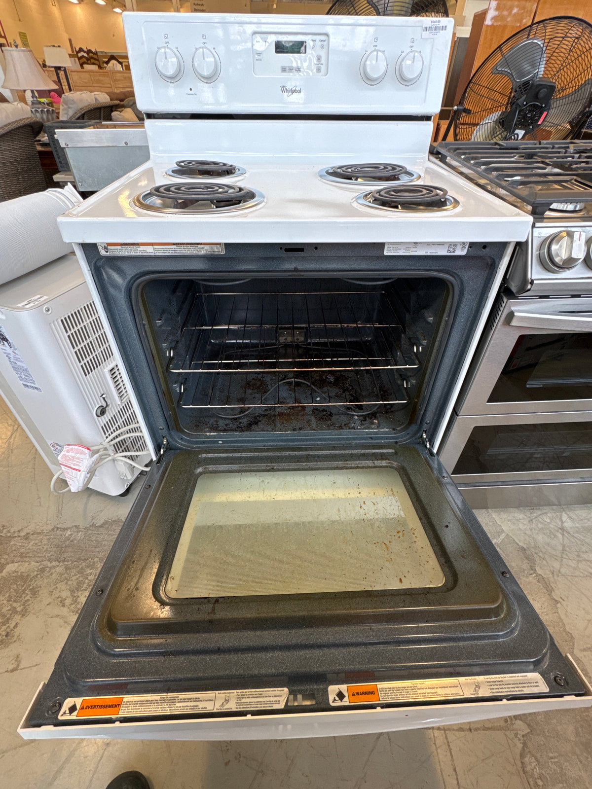 White Whirlpool Freestanding Electric Range Featuring A Four-Coil Burner Cooktop And A Rear Control Console.