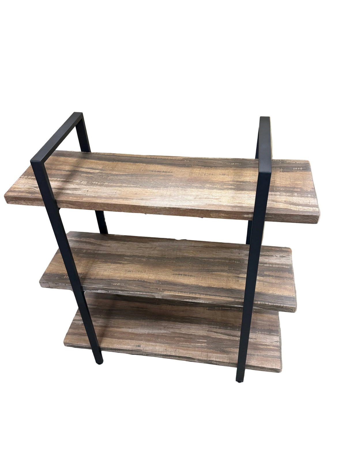 A three-tier wooden shelf with a dark wood grain finish and black metal frame legs, shown in a furniture store setting.