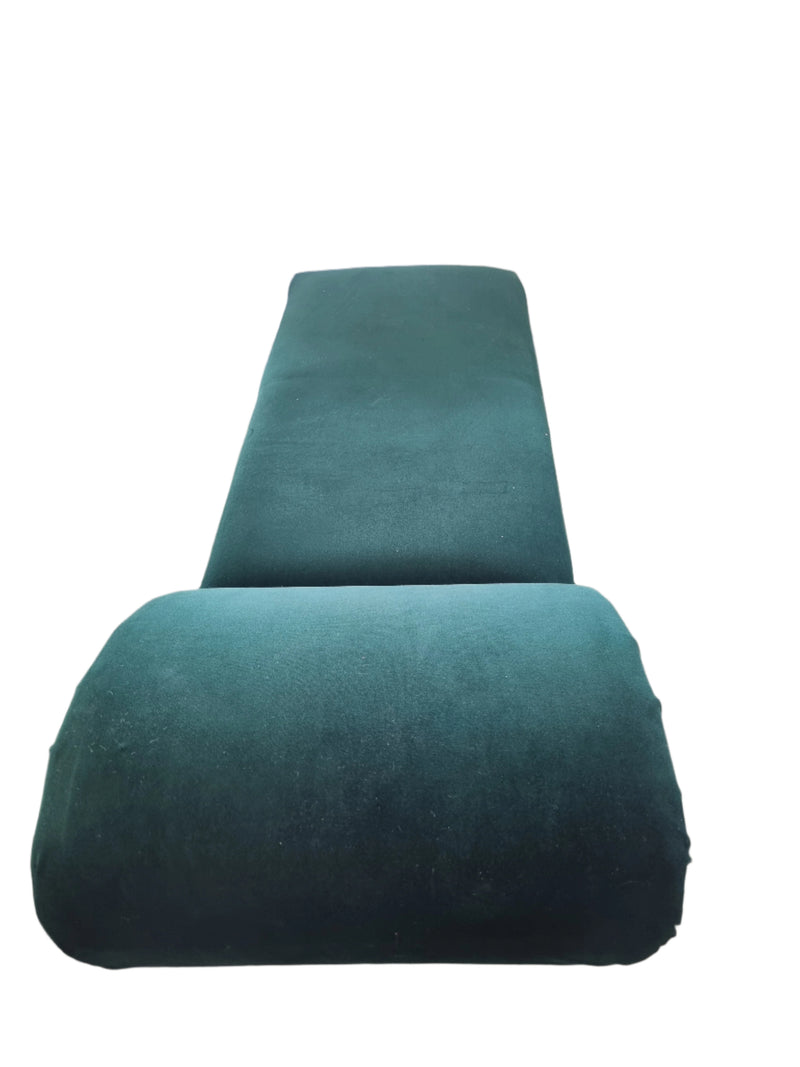 A vintage- style chaise lounge with green velvet