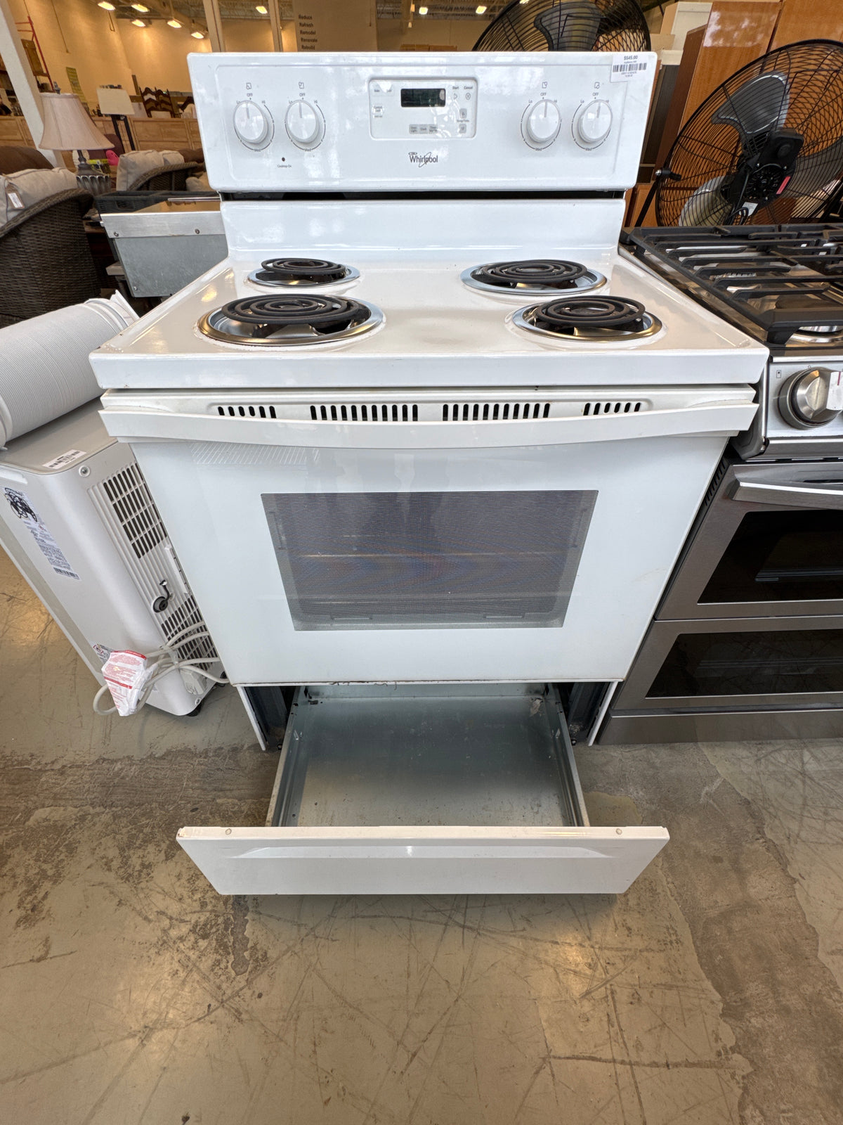 White Whirlpool Freestanding Electric Range Featuring A Four-Coil Burner Cooktop And A Rear Control Console.