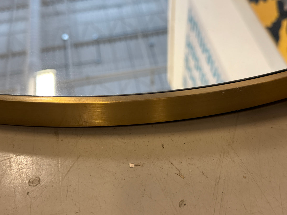 Round Wall Mirror With a Thin Metallic Frame