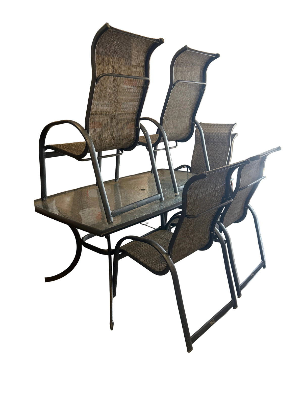 A set of six outdoor patio chairs with dark gray mesh seats and backs, paired with a matching rectangular glass-top table, photographed in a warehouse or furniture store setting.