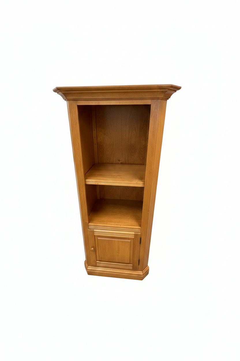 A large wooden writing desk with open shelves and cabinet doors, photographed in a furniture store showroom.