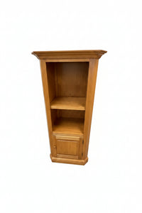 A large wooden writing desk with open shelves and cabinet doors, photographed in a furniture store showroom.