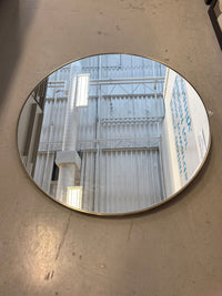 Round Wall Mirror With a Thin Metallic Frame