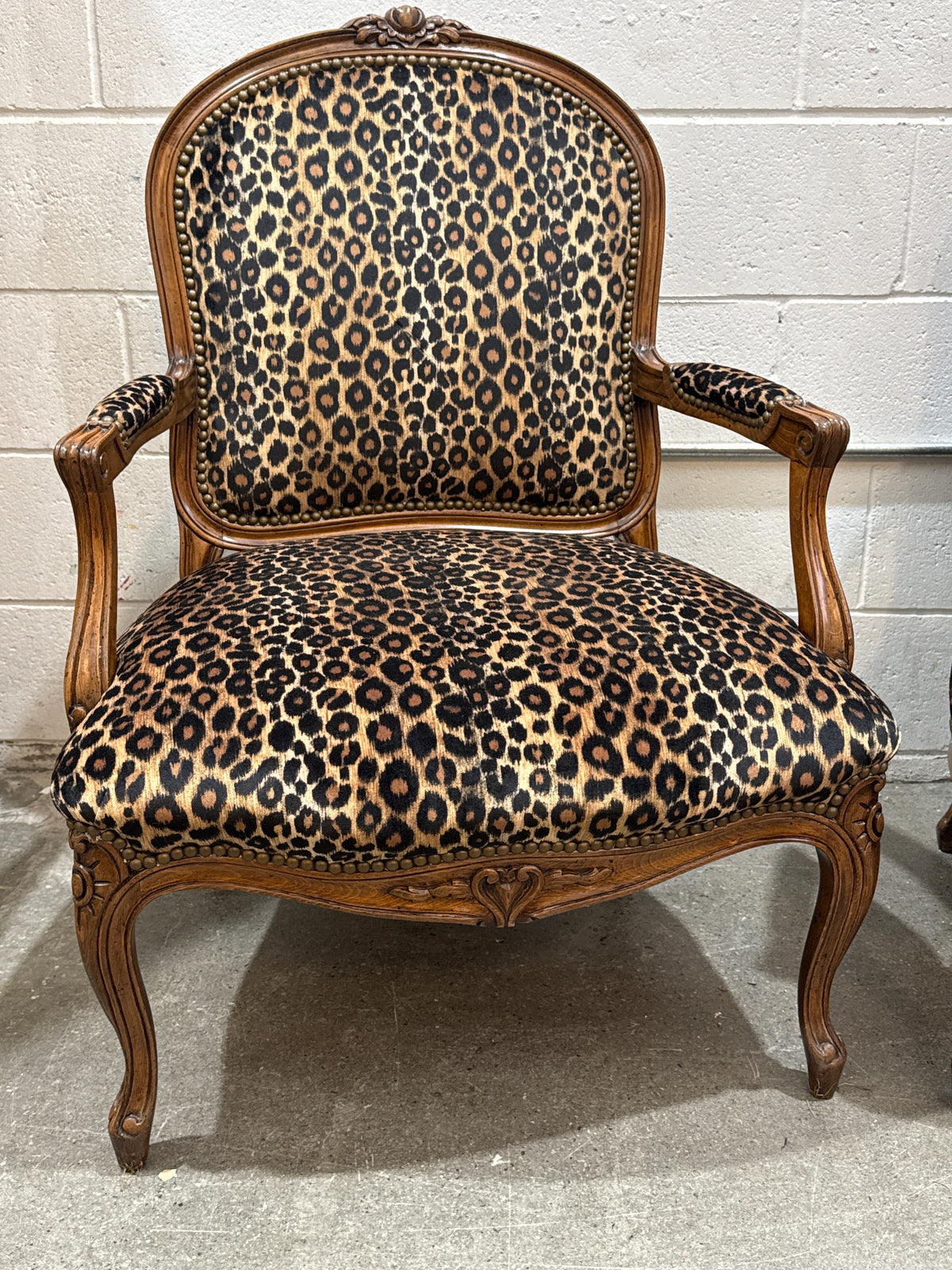 Vintage French Louis XV-style Carved Wood Armchair Featuring Striking Leopard-Print Upholstery and Elegant Cabriole Legs.