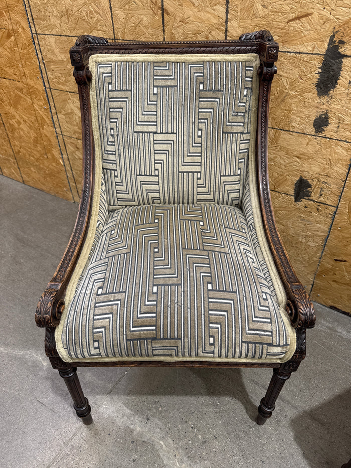 Antique French Louis XVI-style Carved Wood Armchair Features a Striking Geometric-Patterned Fabric Upholstery.