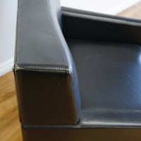 28×32×33‑Inch Black Leather Armchair – Angular Profile, Cushioned Seat & Back