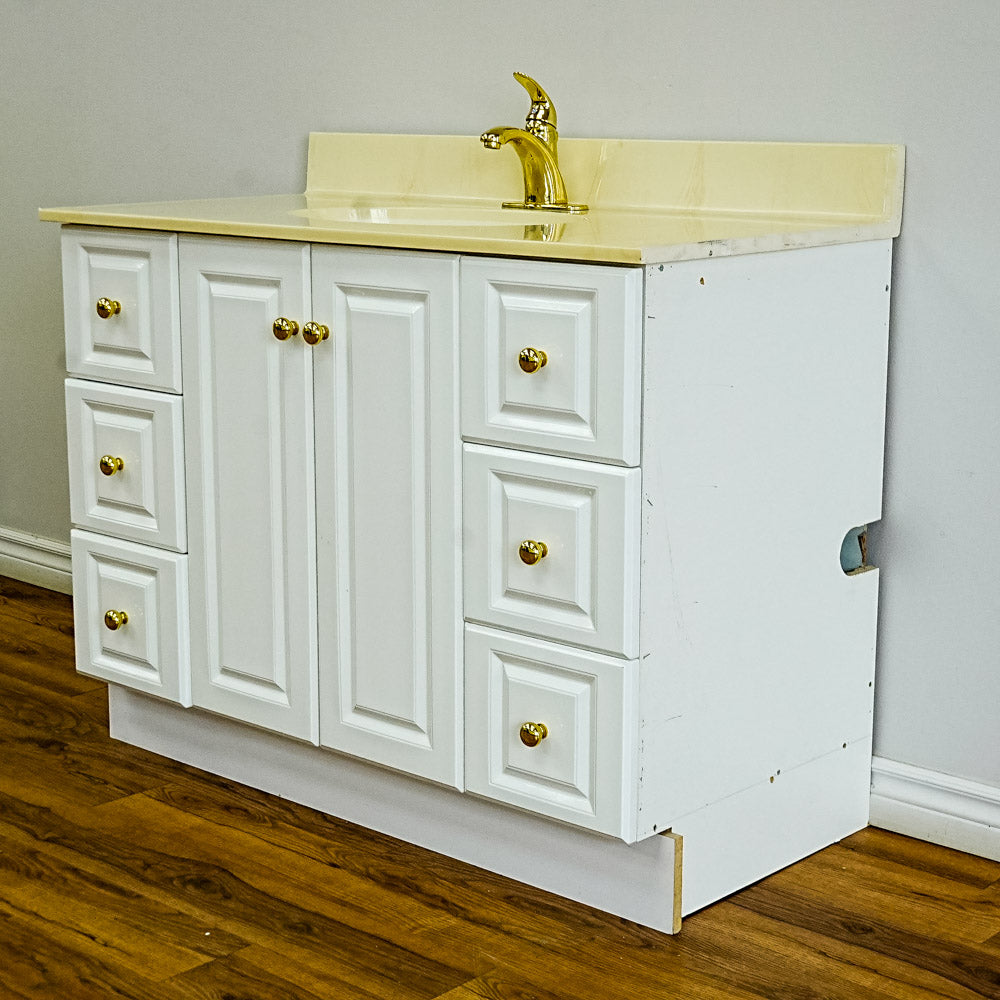 White Bathroom Vanity with Yellow Countertop, Gold Faucet, and Sink