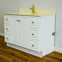 White Bathroom Vanity with Yellow Countertop, Gold Faucet, and Sink