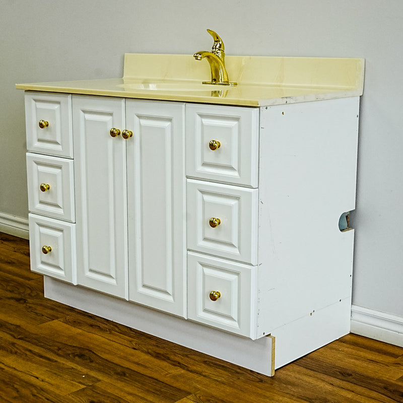 White Bathroom Vanity with Yellow Countertop, Gold Faucet, and Sink