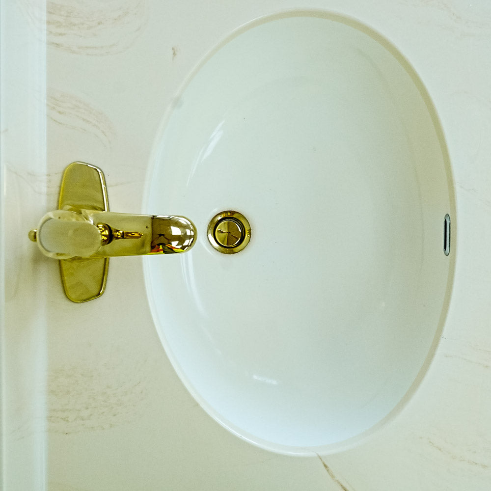White Bathroom Vanity with Yellow Countertop, Gold Faucet, and Sink