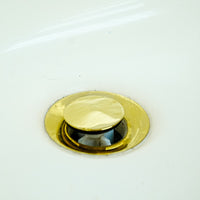 White Bathroom Vanity with Yellow Countertop, Gold Faucet, and Sink