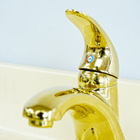 White Bathroom Vanity with Yellow Countertop, Gold Faucet, and Sink