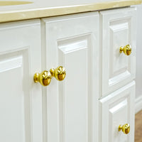 White Bathroom Vanity with Yellow Countertop, Gold Faucet, and Sink