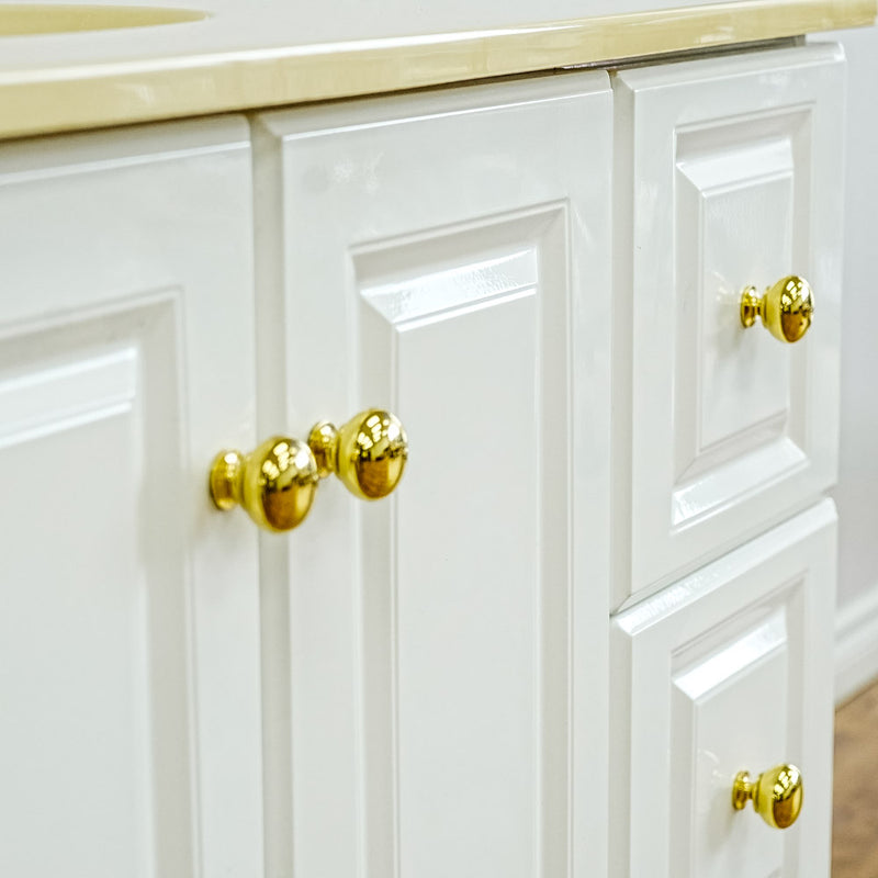 White Bathroom Vanity with Yellow Countertop, Gold Faucet, and Sink