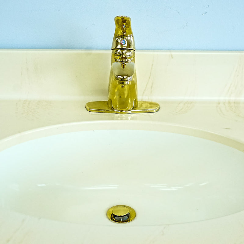 White Bathroom Vanity with Yellow Countertop, Gold Faucet, and Sink