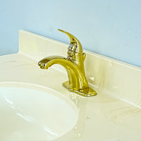 White Bathroom Vanity with Yellow Countertop, Gold Faucet, and Sink