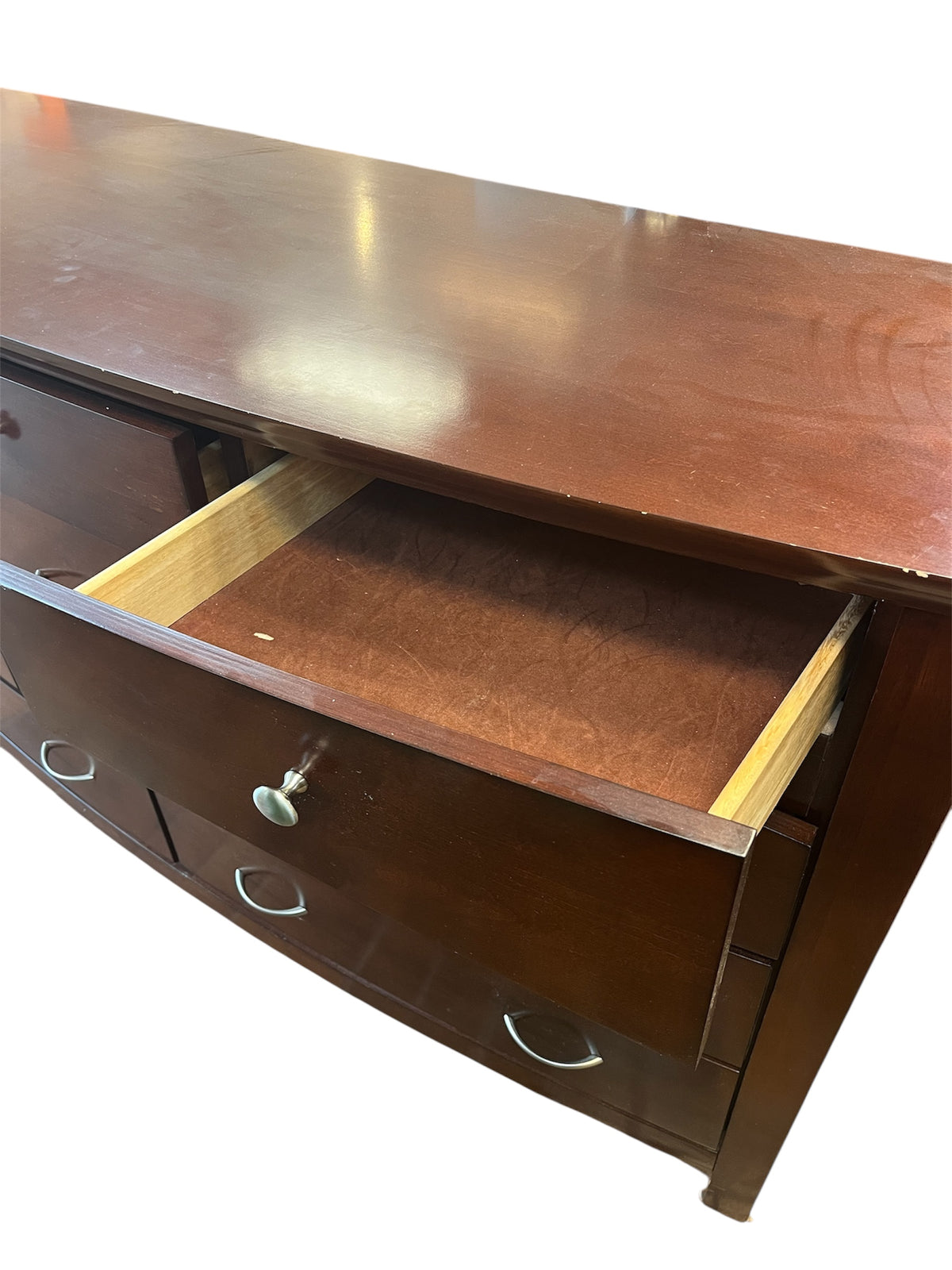 Dark Brown Curved Dresser With Silver Hardware