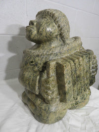 "Kneeling Inuk Playing Accordion" - Stone Carving