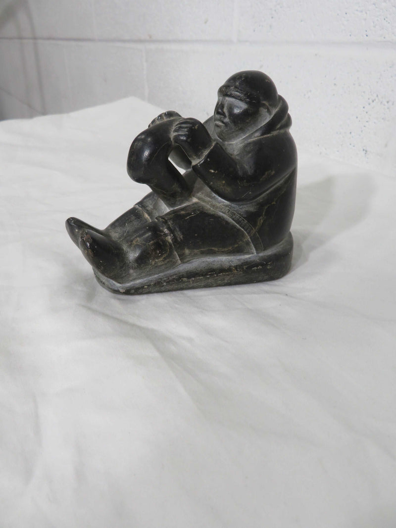 "Seated Man with Kamik" - Stone Carving