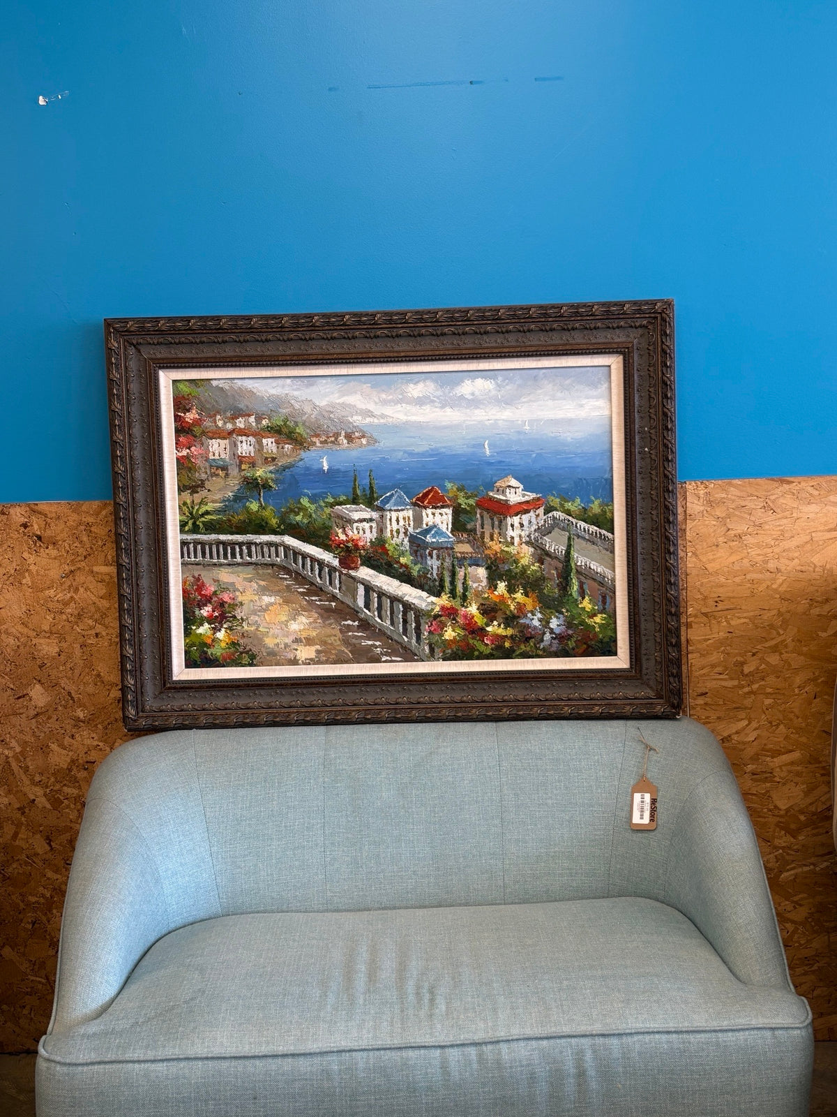 Mediterranean townscape with vibrant flowers, buildings, and the sea