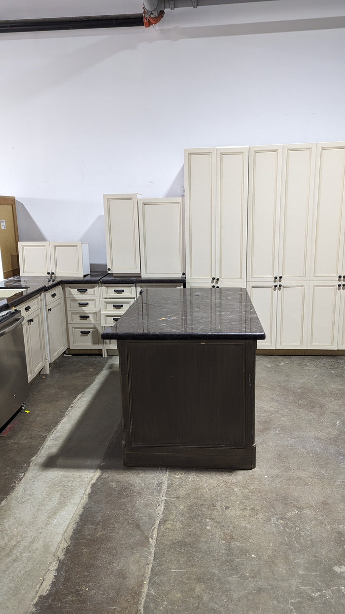 Beige Kitchen w/ Brown Island & Black Granite Countertops