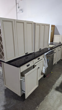 Beige Kitchen w/ Brown Island & Black Granite Countertops