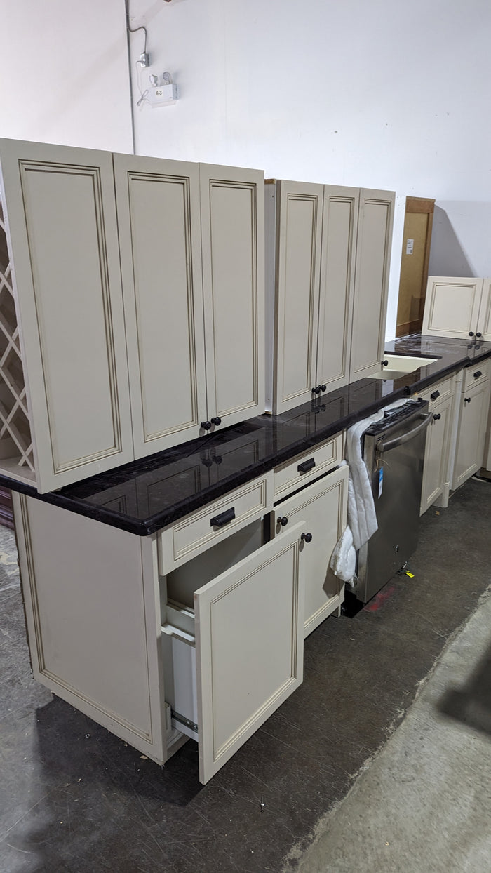 Beige Kitchen w/ Brown Island & Black Granite Countertops