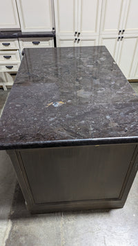 Beige Kitchen w/ Brown Island & Black Granite Countertops
