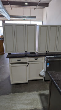 Beige Kitchen w/ Brown Island & Black Granite Countertops