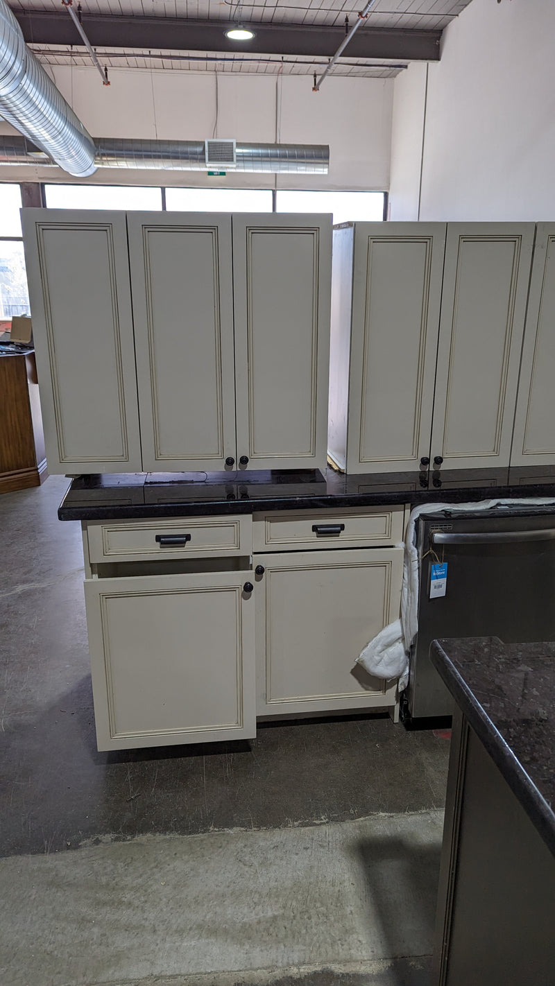 Beige Kitchen w/ Brown Island & Black Granite Countertops