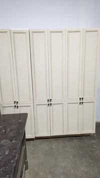 Beige Kitchen w/ Brown Island & Black Granite Countertops
