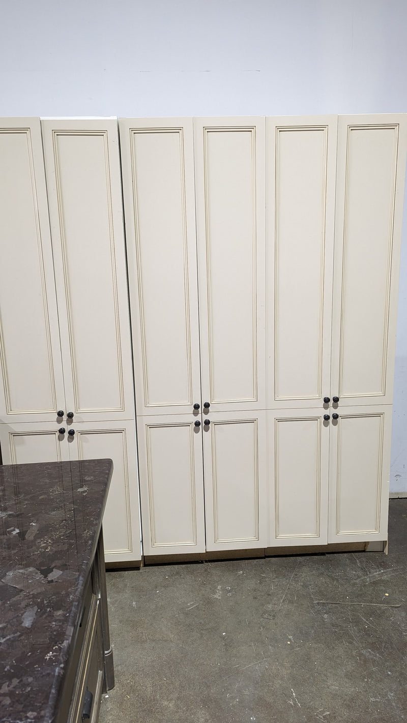 Beige Kitchen w/ Brown Island & Black Granite Countertops
