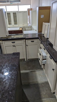 Beige Kitchen w/ Brown Island & Black Granite Countertops