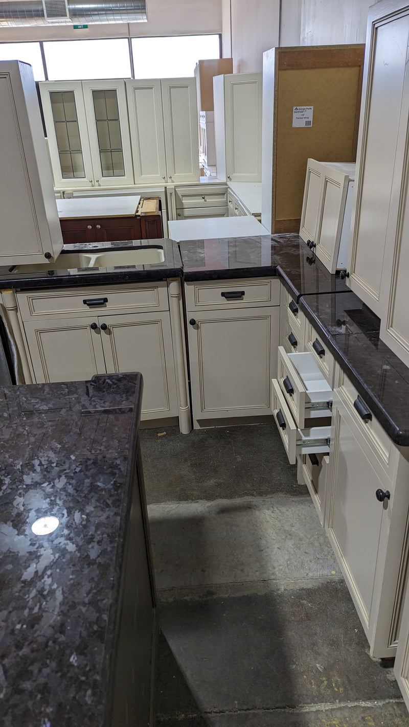 Beige Kitchen w/ Brown Island & Black Granite Countertops
