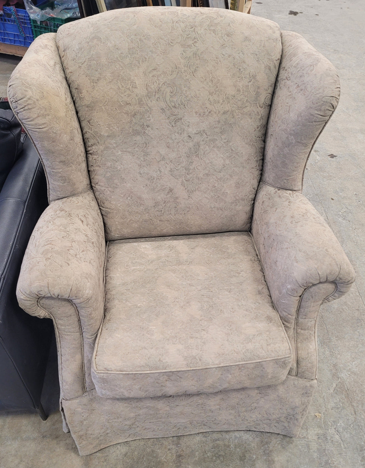 Beige Upholstered Wingback-Style Armchair