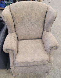 Beige Upholstered Wingback-Style Armchair
