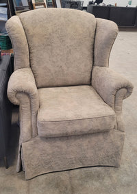 Beige Upholstered Wingback-Style Armchair
