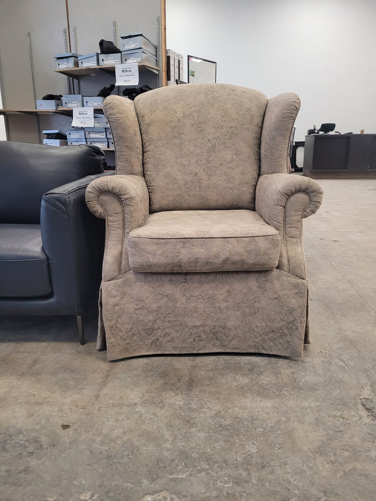 Beige Upholstered Wingback-Style Armchair